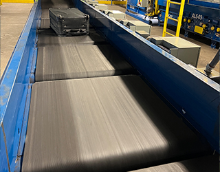 Luggage being conveyed on airport conveyor belt